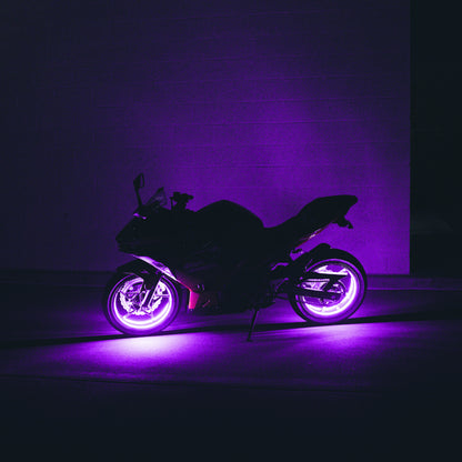 Motorcycle with purple glowing wheels against a dark background