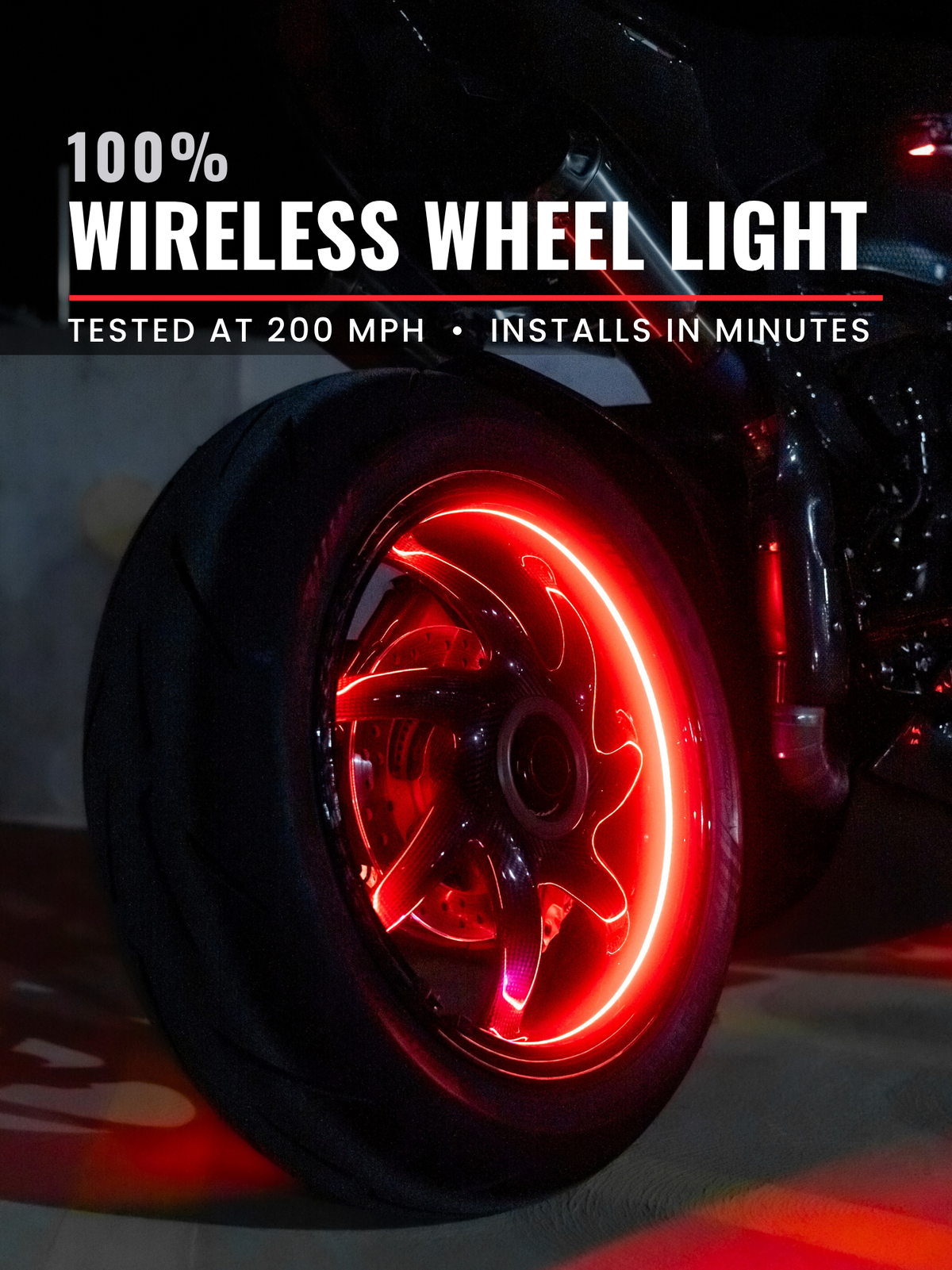 A close-up of a motorcycle wheel with a glowing red wireless wheel light mounted in the center, with bold text at the top reading '100% WIRELESS WHEEL LIGHT' and smaller text 'TESTED AT 200 MPH • INSTALLS IN MINUTES'.