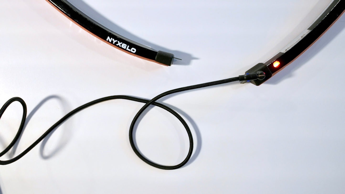 Nyxglo wireless motorcycle wheel light charging with magnetic USB charger cable.