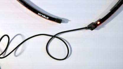 Nyxglo wireless motorcycle wheel light charging with magnetic USB charger cable.
