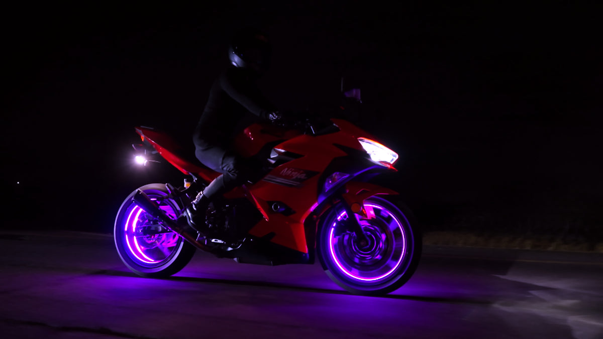 Motorcycle with purple wheels on a dark background
